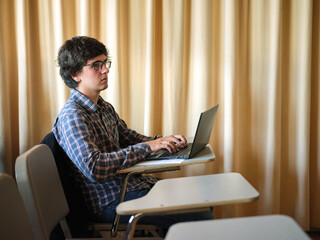 Student with computer at classroom