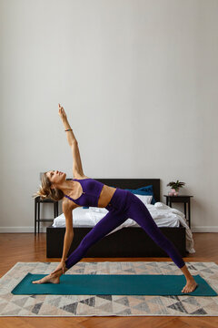 Lady doing gate yoga exercise in bedroom