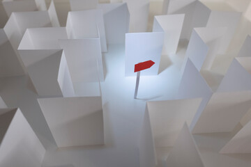 How do we get out of this? a red paper arrow points the way out of a white paper maze.