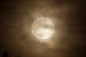 full moon in the night sky with clouds