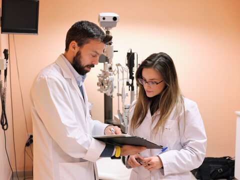 Professor and student at optician practice
