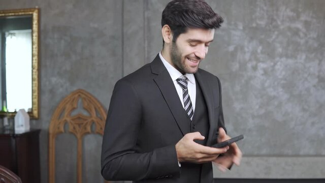 Footage B roll of Business man in a suit using smartphone deal a customer and manage order. entrepreneur startup businessman using smartphone networking application checking email time business news.