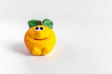Children's rubber toy apple, on a white background. Development and games with children. Space for text.
