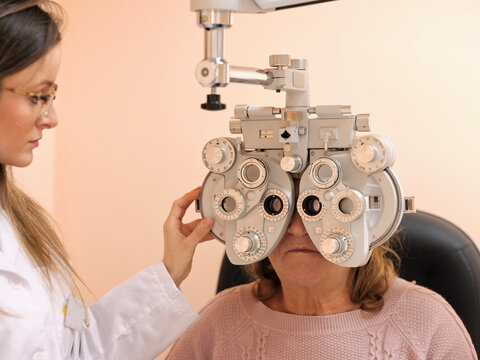 Young optometrist examining pacient