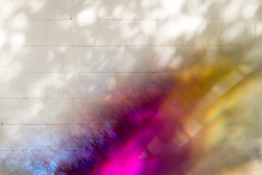 Rainbow Reflected On A White Brick Wall