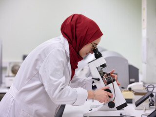 Young muslim woman in a lab