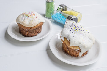 traditional ukrainian Easter cake kulich with glaze on a white wooden background Russian pastry.