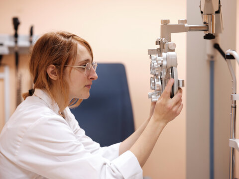 Young optometrist with technical equipment