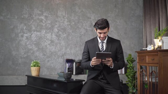 Footage B roll A Cheerful guy is working in office making mobile phone call and using laptop taking notes in notebook. Business communication. Work from home , business technology concept. 