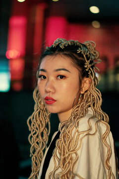 portrait of young asian woman on the street at night