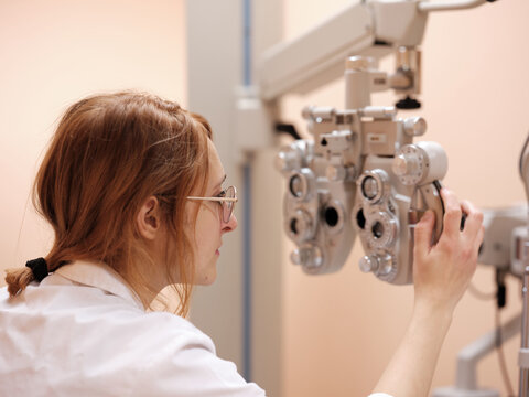 Young optometrist with technical equipment