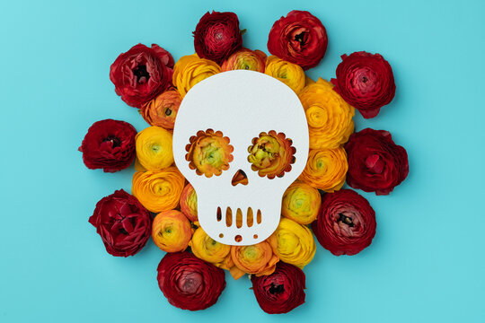 Day of the dead skull on aqua with flowers