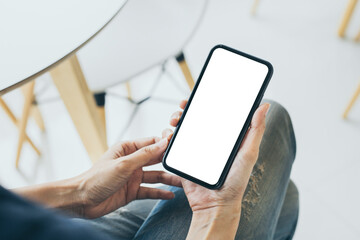 cell phone mockup blank white screen.woman hand holding texting using mobile on desk at coffee shop.background empty space for advertise.work people contact marketing business,technology