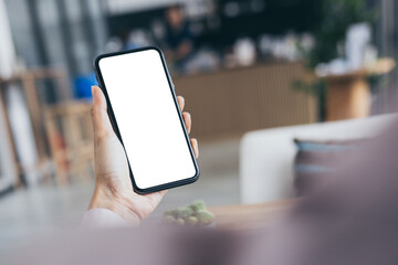 cell phone mockup blank white screen.woman hand holding texting using mobile on desk at coffee shop.background empty space for advertise.work people contact marketing business,technology