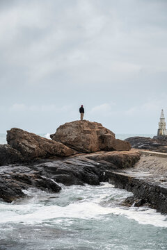 Man on a rocky seashore