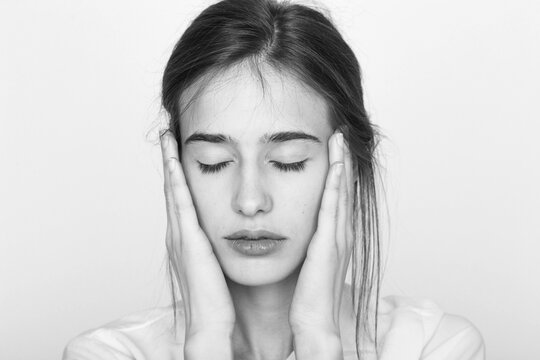 Portrait of a girl touching her face in black and white