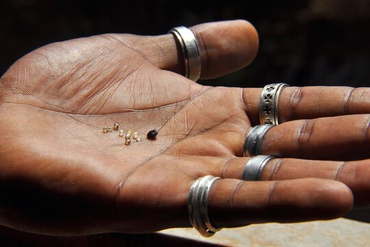 Hand holding rough diamonds, Chapada Diamantina, Bahia, Brazil, South America