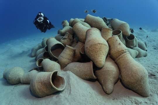 Diver looking at amphoras on a sandy bottom, Makadi Bay, Hurghada, Egypt, Red Sea, Africa