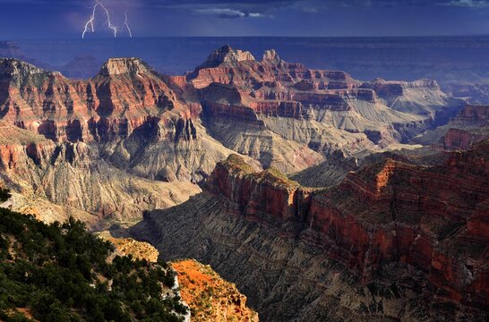 Thunderstorm with a lightning strike, view from Bright Angel Point towards Deva Temple, Brahma Temple, Zoroaster Temple, Transept Canyon, Bright Angel Canyon, sunset, evening mood, Grand Canyon National Park, North Rim, Arizona, United States of America, USA, North America