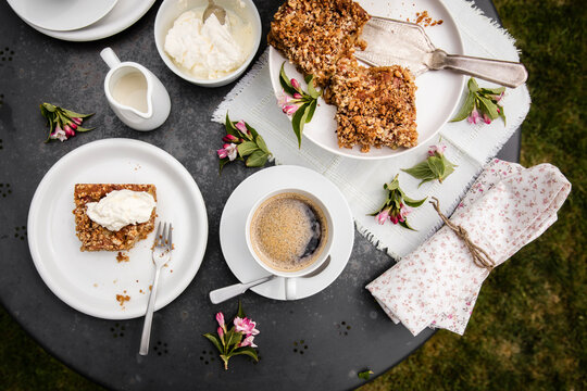 Cup Of Coffee And Homemade Rhubarb Cake On Garden Coffee Table