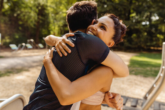 Man and woman hugging on a fitness trail