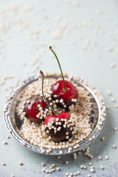 High angle view of chocolate covered cherries and quinoa in plate