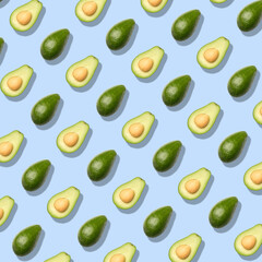Pattern with avocado. Abstract blue background. Top view