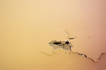 Yellow concrete walls with cracks