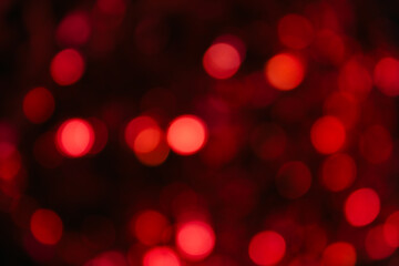 Fototapeta premium red bokeh on a black background, out of focus, red background, blurry background, round lights in out of focus, horizontal