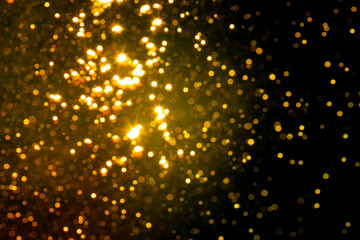 Bokeh gold from natural water with black background