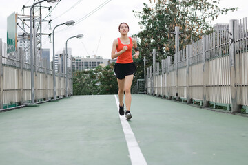 Fototapeta premium Young Asian healthy female running on street. Fitness and exercise concept.
