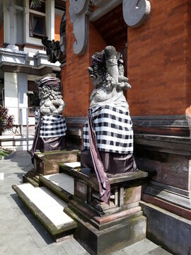two statues with Balinese sculptures
