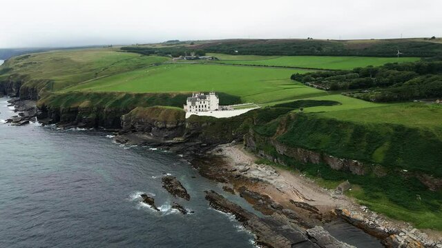 Picturesque Landscape Of Dunbeath Castle Situated On The Edge of A Rocky Peninsula In Caithness, Dunbeath, Scotland, UK.  - aerial drone shot