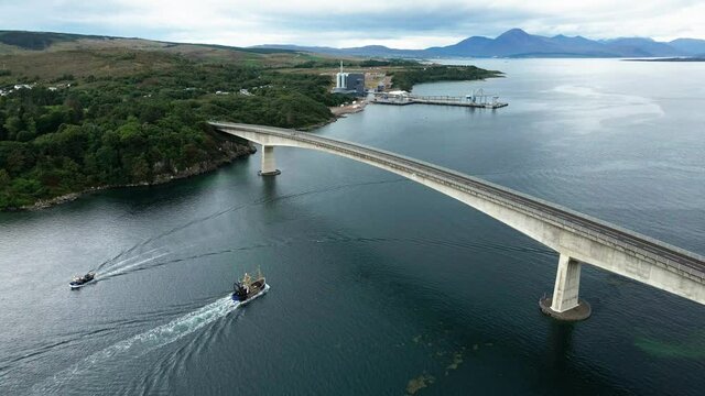 Fishing Trawlers Sailing At Loch Alsh And Passing Under The Skye Bridge With Kyleakin Plant In The Background In Scotland, United Kingdom.  - aerial drone, Mavic air 2