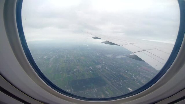 Zooming into view out of plane window while travelling onto next adventure (slow motion)