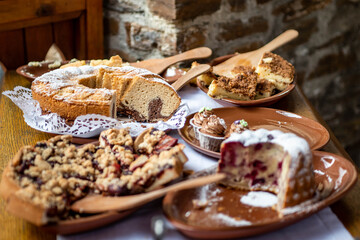 Table full with beautiful and delicious cakes at wedding reception Buffet