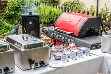 Large barbecue grill and smoker setup with sauces grilling meat bbq Party food outdoor garden party