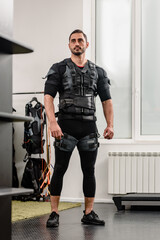 Portrait of young athletic man posing in EMS suit