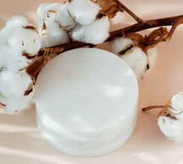 Marble podium , cotton flowers and floral shadows on pink background top view. Empty showcase for cosmetic product presentation, promotion sale.copy space White marble pedestal backdrop.