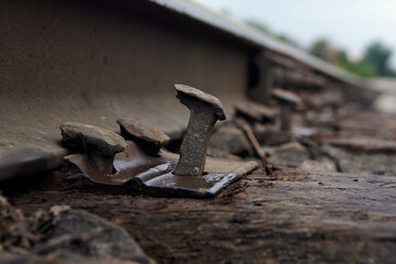 Close up abandoned rusty nail with wooden sleepers.