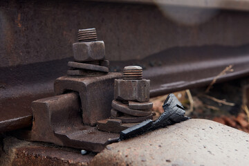 Detail of old rusty screws on railroad track.