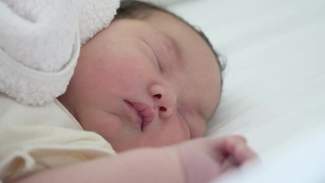 Close up shot of a newborn asian baby sleeping.