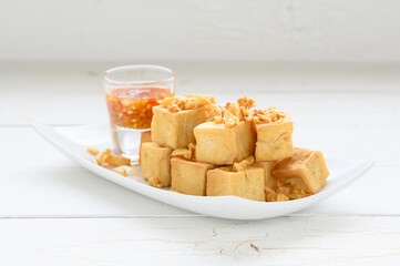 Deep fried tofu is cut into square balls on plate