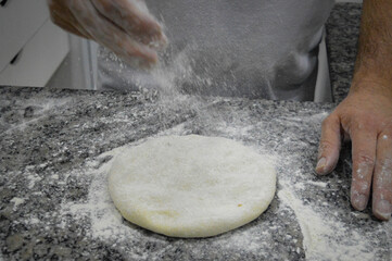 person kneading dough