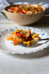 A plate of  delicious macaroni pasta with fork served from a bowl.