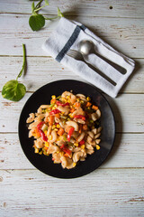 A plate full of pasta with vegetables and meat