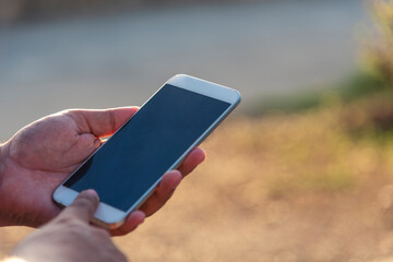 Man hands holding mobile phone outdoor surfing internet online technology lifestyle. Man close up hand using smartphone gadget text message focus empty blank screen smart phone. Mobile phone lifestyle