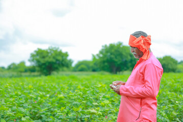 Excited farmer holding Indian rupee notes
