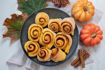 sweet home made autumn cinnamon rolls with pumpkin