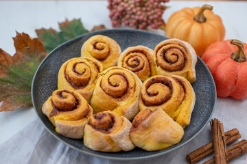sweet home made autumn cinnamon rolls with pumpkin